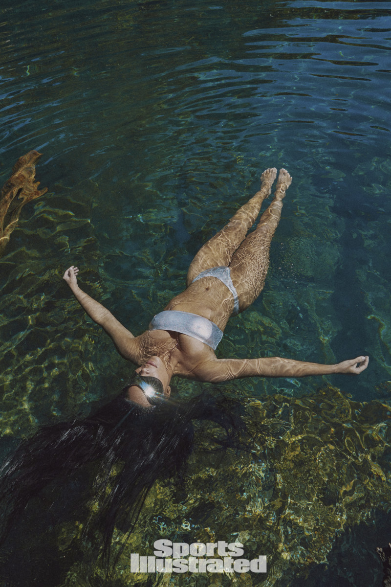 Kim Kardashian was photographed by Greg Swales in the Dominican Republic. Swimsuit by SKIMS. Sunglasses by Balenciaga.